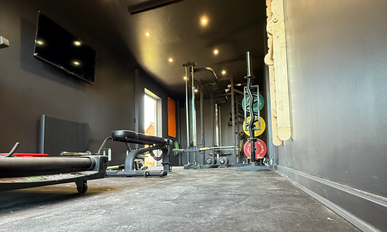 An extended view of a garage conversion into a home gym